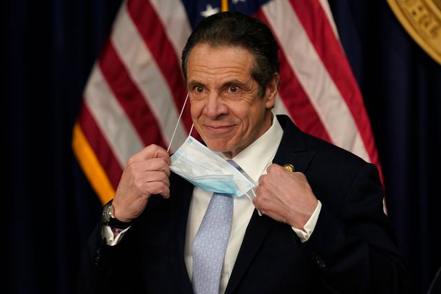 New York Governor Andrew Cuomo removes his mask at the start of an event on March 18th, 2021.